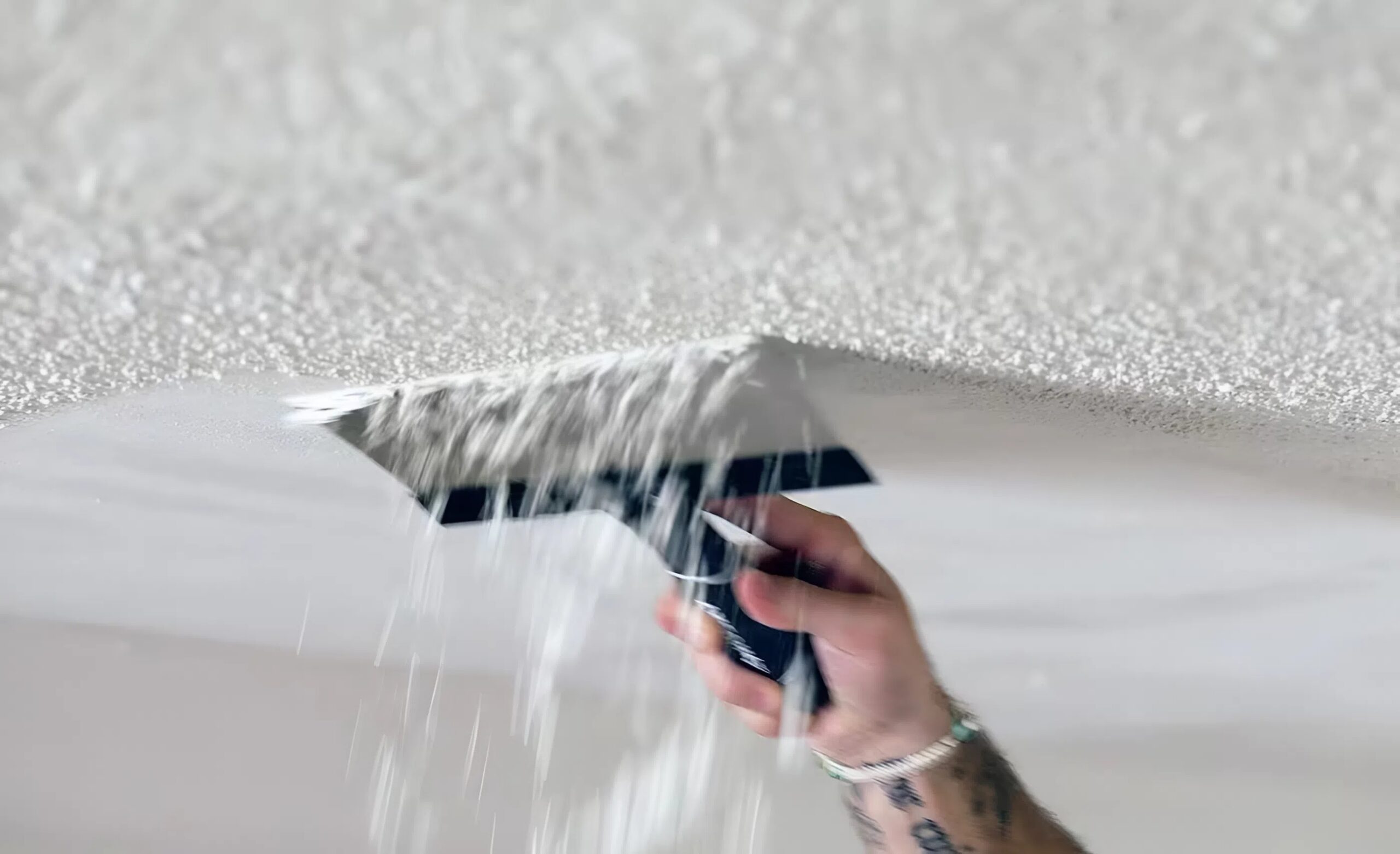 A painter in San Luis Obispo County, CA, removing popcorn ceiling