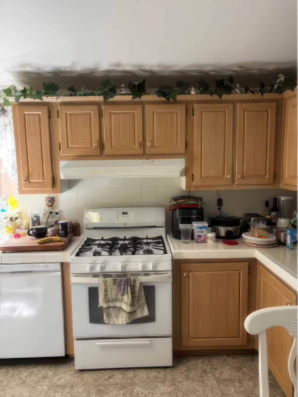 White kitchen interior with refinished cabinets and stove White kitchen with refinished cabinets