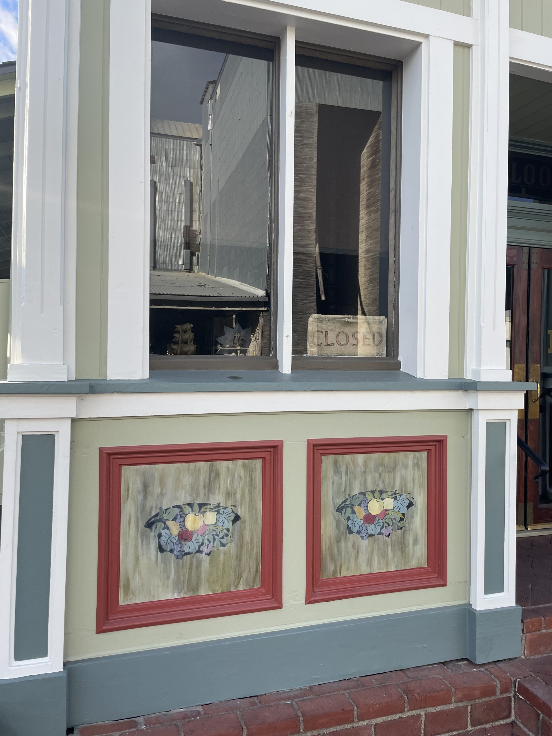 Mediterranean stucco store exterior with red trim painting Mediterranean store with stucco and red trim