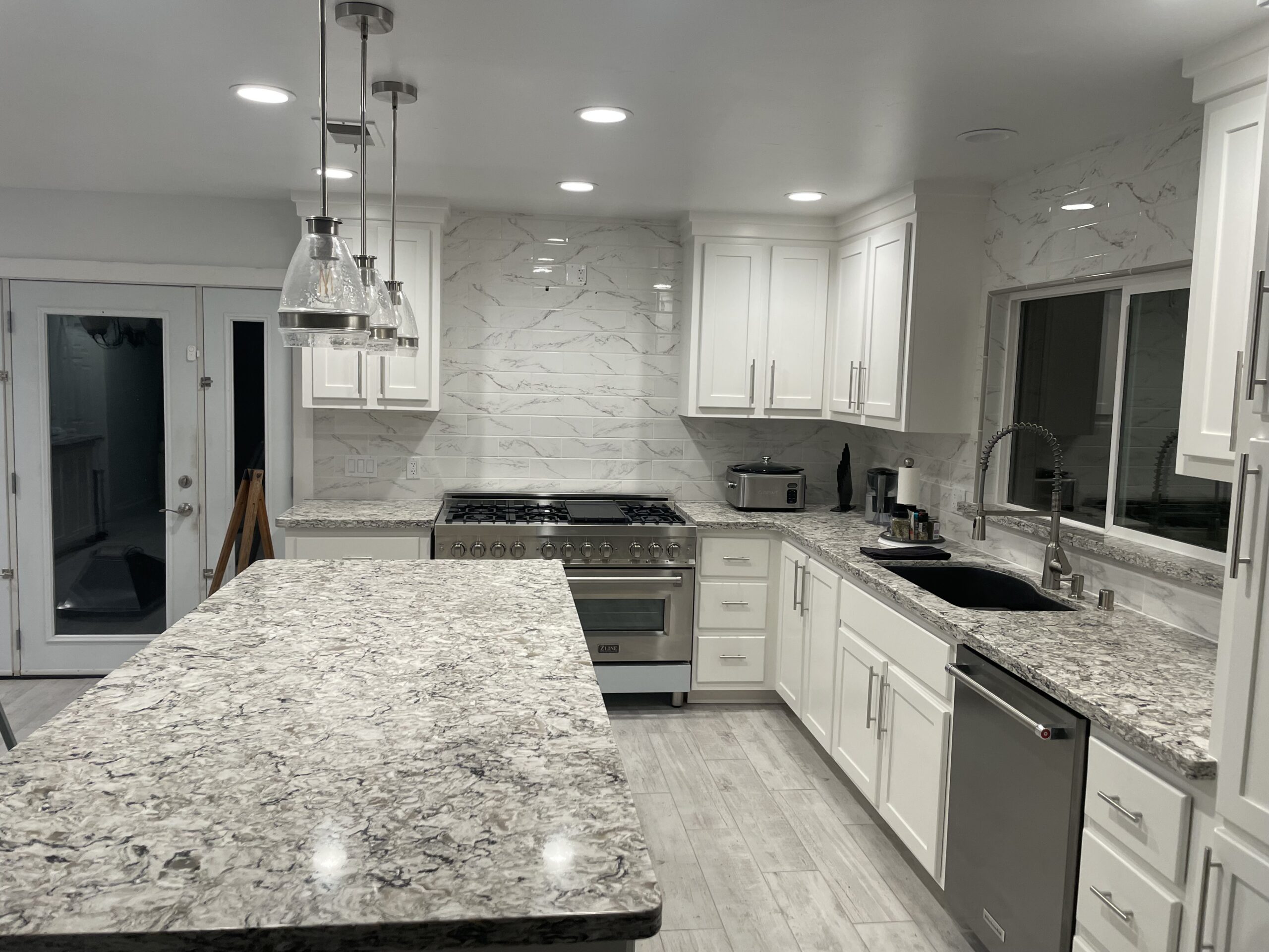 White refinished kitchen cabinets with chandelier White kitchen with chandelier