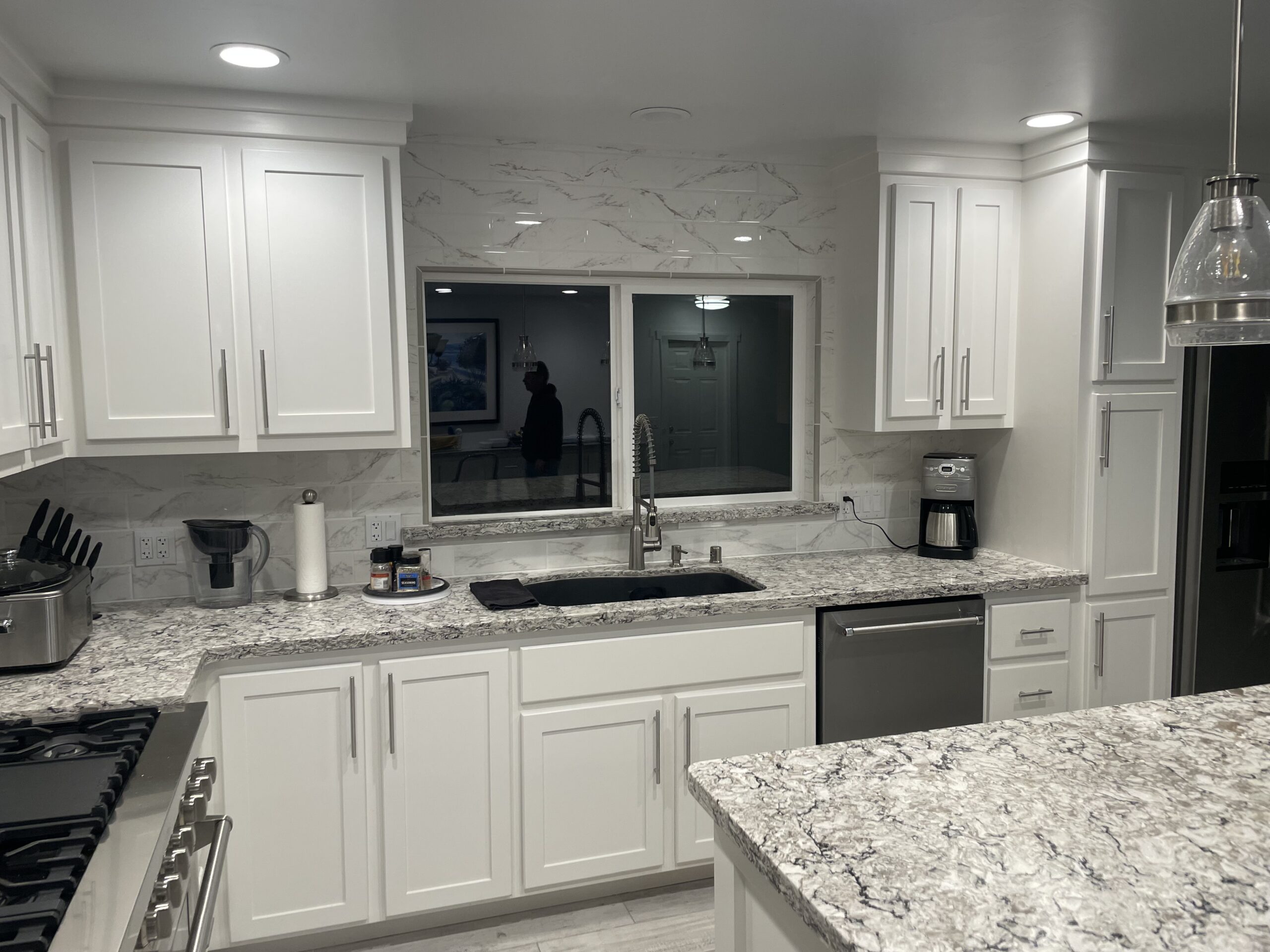 White kitchen cabinet refinish with marble countertops White kitchen with marble countertops